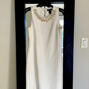 Rhinestone/Pearl embellishments highlight this little white dress